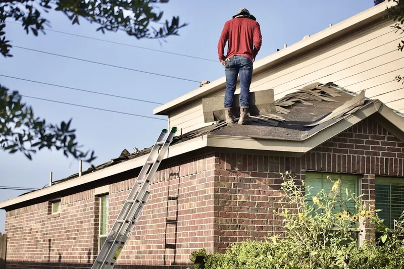 Professional roofer working on a residential roof in Old Greenwich